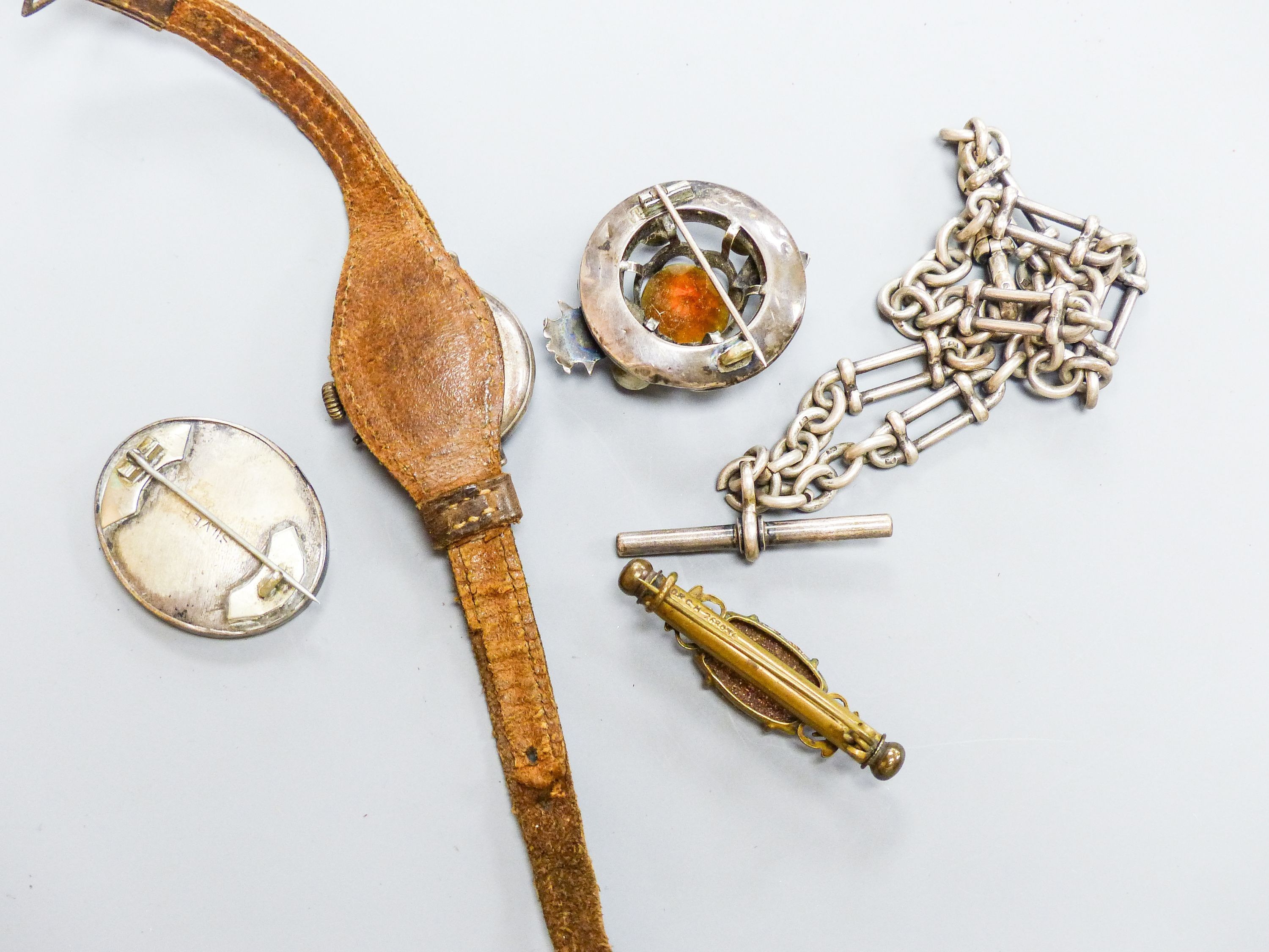 A white metal, paste and enamel set brooch, 40mm, a silver albert, two brooches and a lady's white metal and enamel wrist watch.